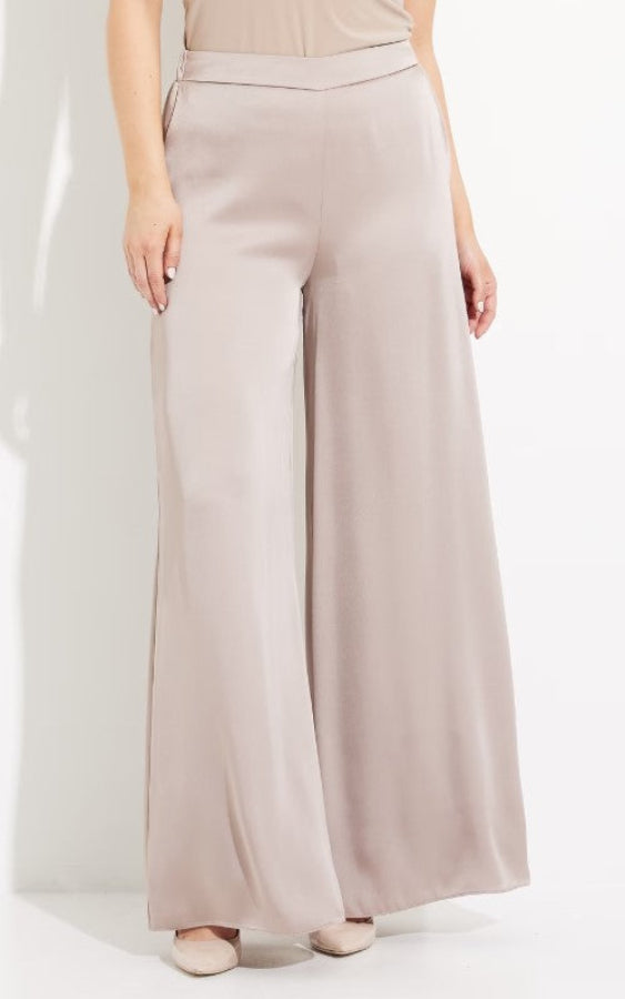 Beige wide-leg pants worn by a person on a white background