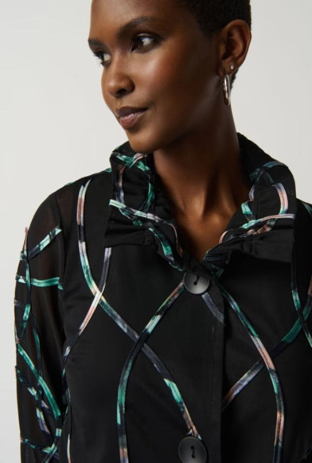 Woman wearing a black coat with colorful abstract patterns on a white background