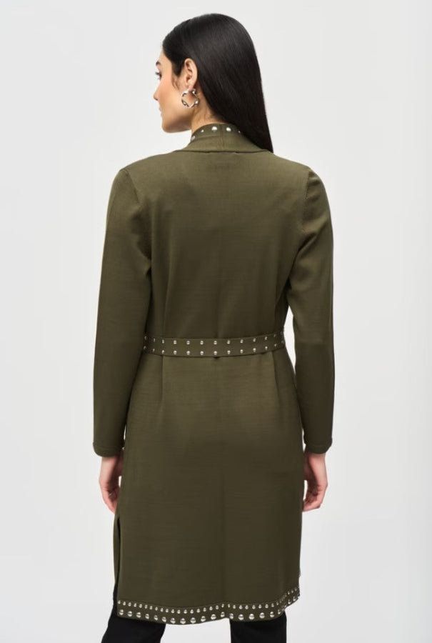 Woman wearing an olive green coat with studded details on a white background