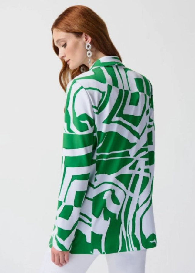 Woman wearing a green and white patterned jacket on a white background