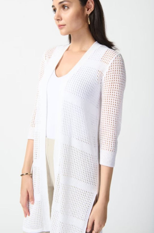 Woman wearing a white knit cardigan over a white top on a white background