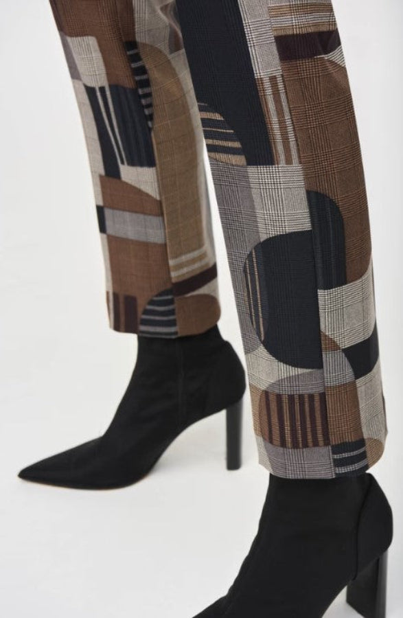 Patterned pants with black high-heeled boots on a white background