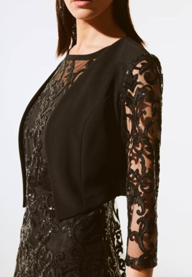 Black lace bolero worn by a model on a white background