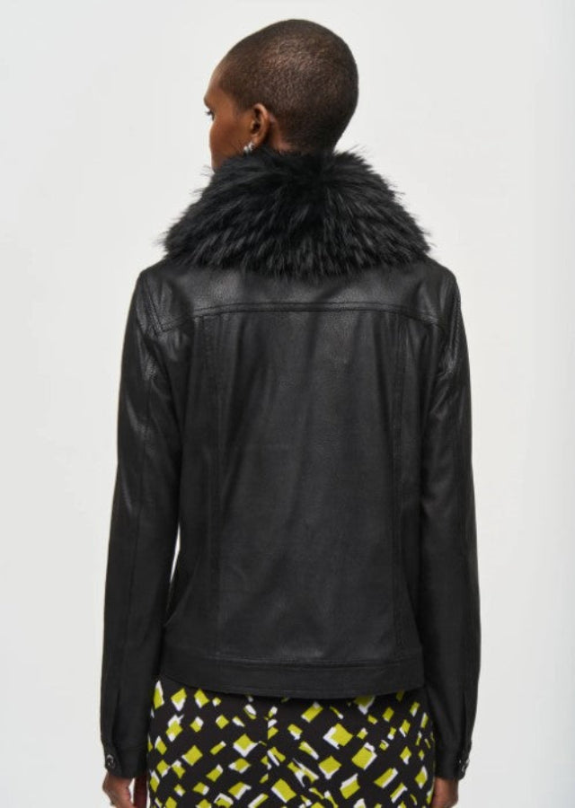 Person wearing a black leather jacket with a fur collar on a white background