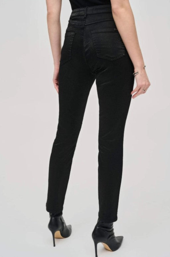 Person wearing black pants on a plain background