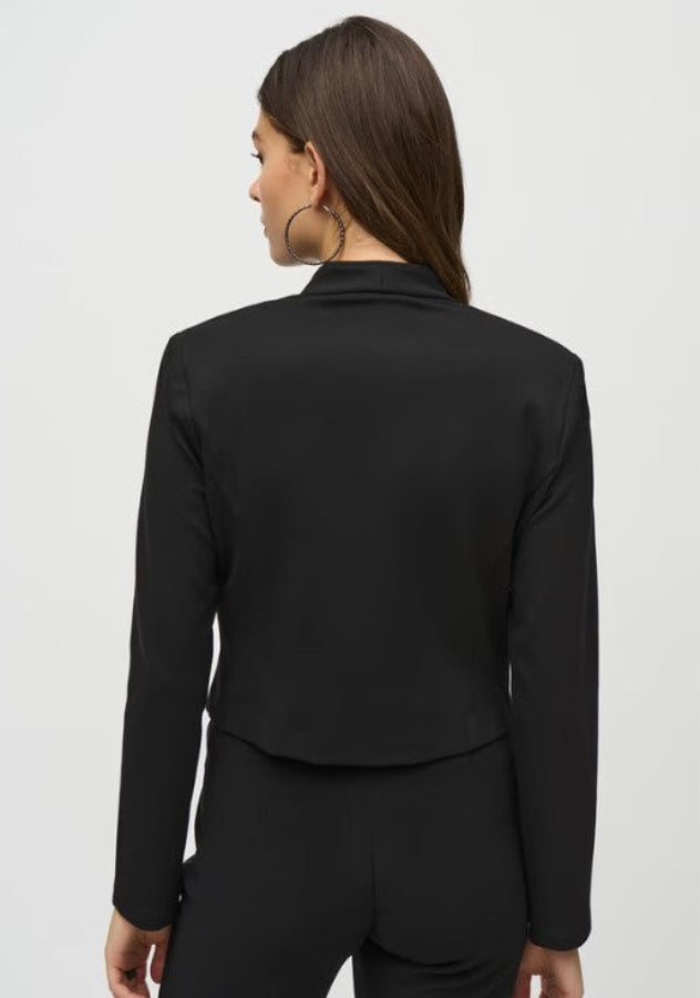 Black blazer worn by a person on a white background