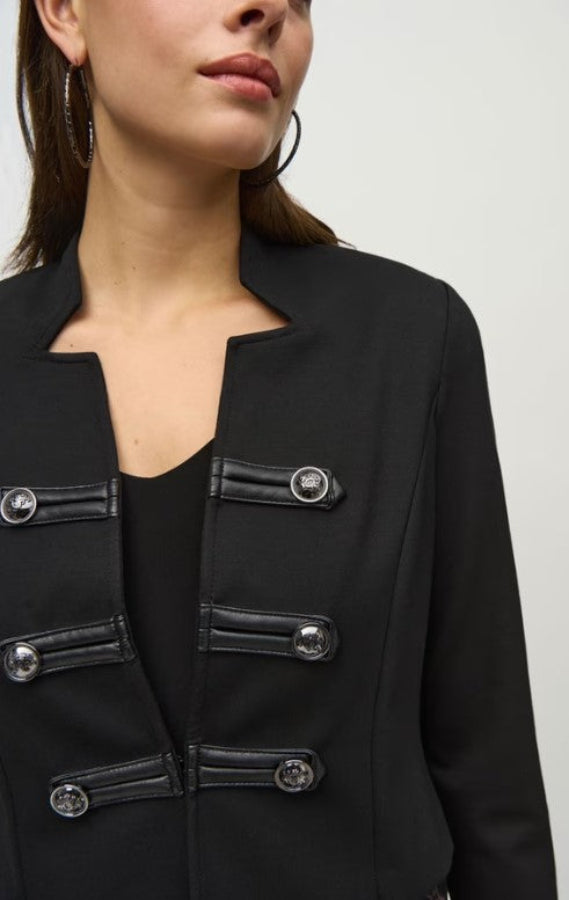 Black jacket with silver buttons worn by a person on a white background
