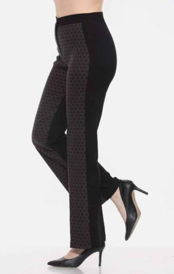 Black patterned pants worn by a person on a white background