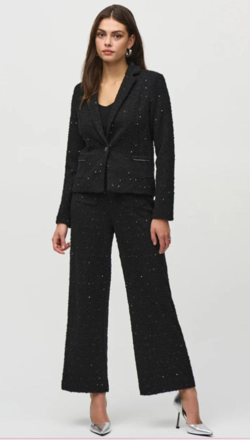 Woman wearing a black suit with a white background