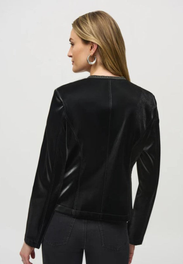 Woman wearing a black jacket with decorative trim on a white background