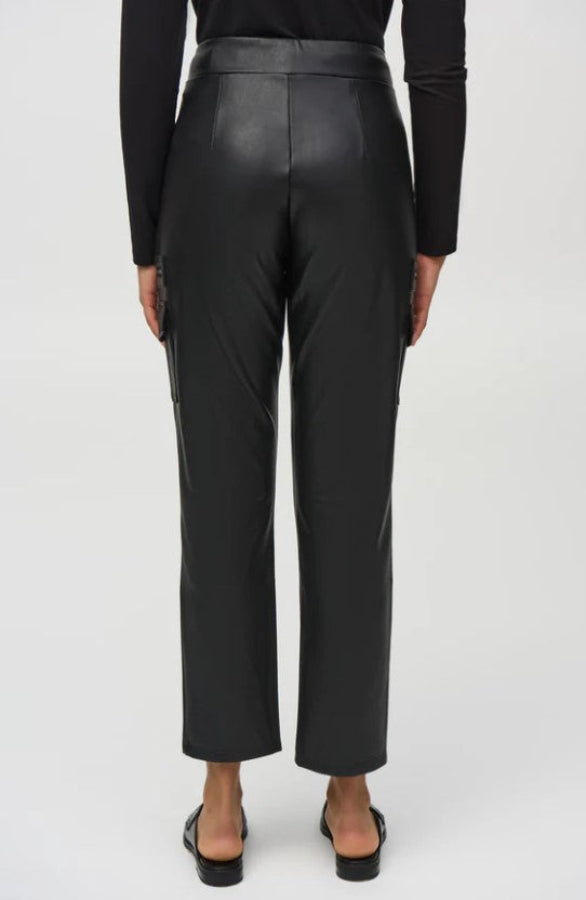 Person wearing black leather pants on a white background
