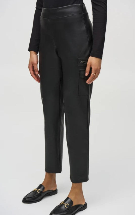 Person wearing black leather pants on a white background