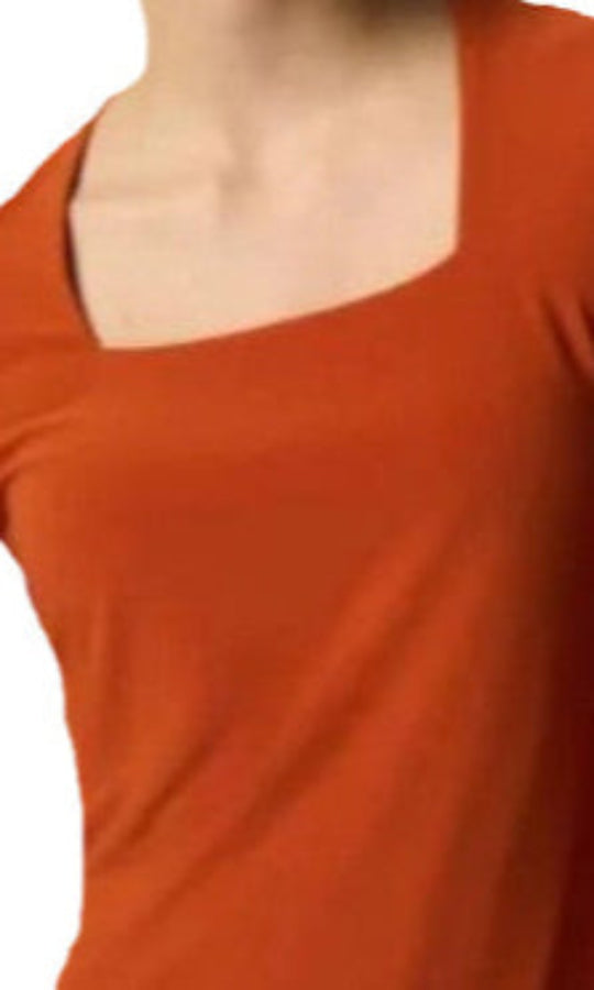 Close-up of a person wearing an orange top on a white background