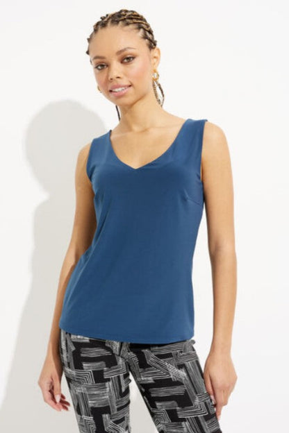 Woman wearing a blue V-neck tank top.