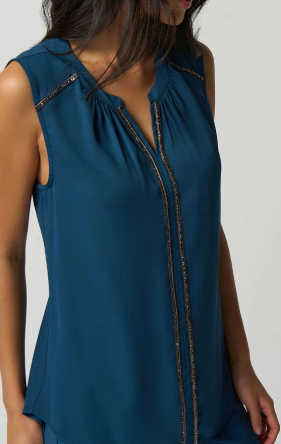 Teal sleeveless top with a zipper detail on a white background