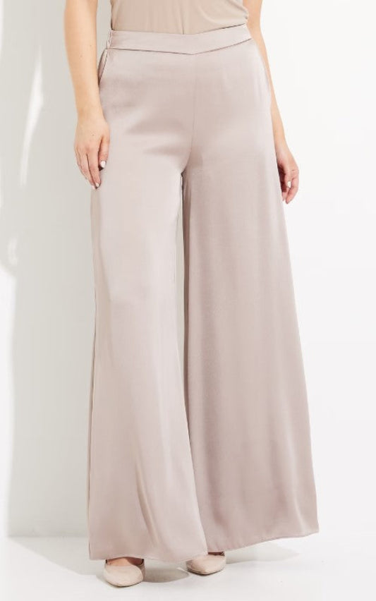 Beige wide-leg pants worn by a person on a white background