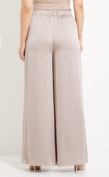 Beige wide-leg pants worn by a person on a white background