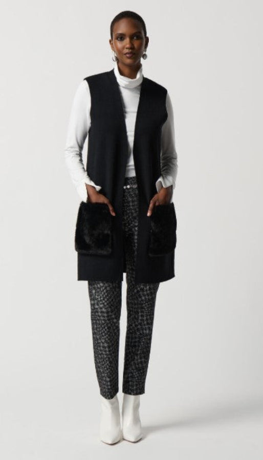 Person wearing a black vest, white shirt, plaid pants, and white boots on a white background