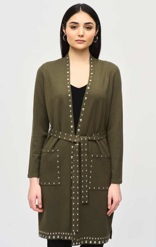 Woman wearing an olive green cardigan with studded details on a white background