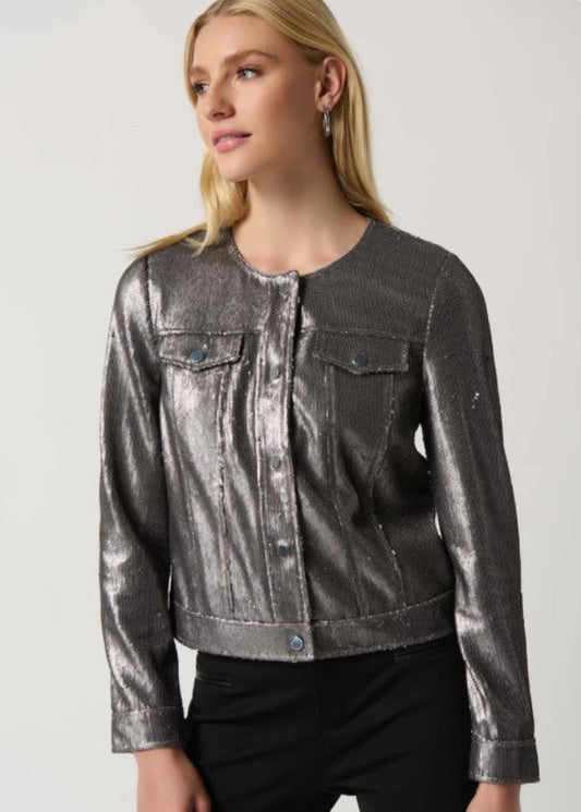 Woman wearing a metallic silver jacket on a plain background