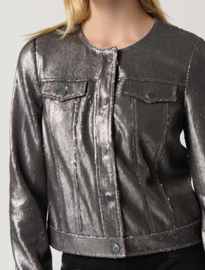 Metallic silver jacket worn by a person on a plain background