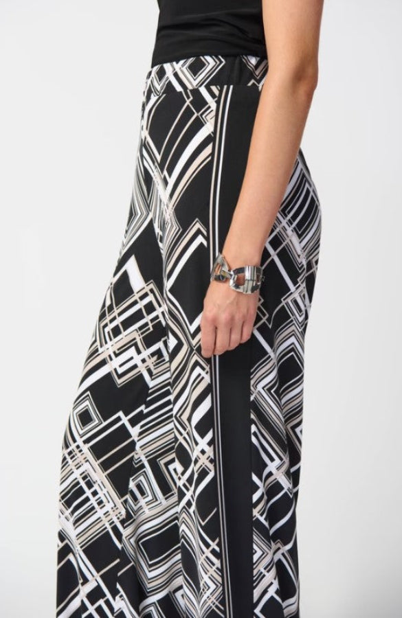 Black and white patterned pants worn by a person on a white background