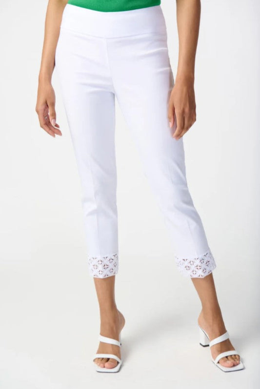 White pants with lace trim worn by a person on a white background
