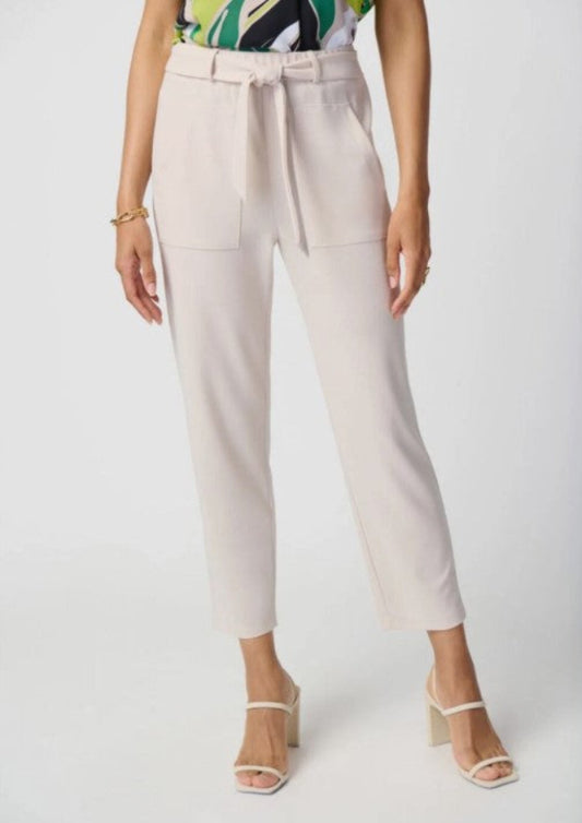 Beige pants worn by a person on a white background