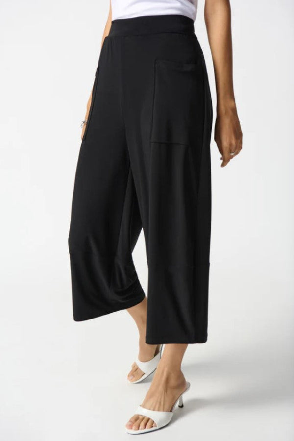 Black wide-leg pants worn by a person on a white background
