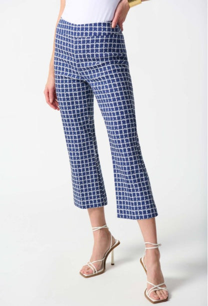 Blue checkered pants worn by a person on a white background