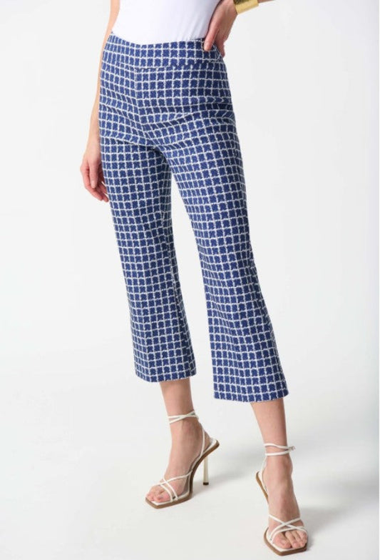 Blue checkered pants worn by a person on a white background