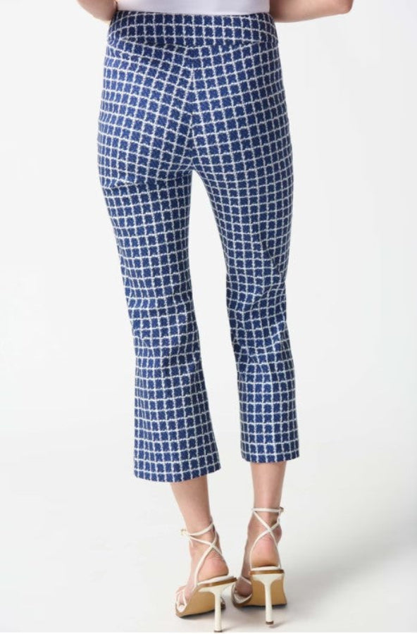Blue checkered pants worn by a person on a white background