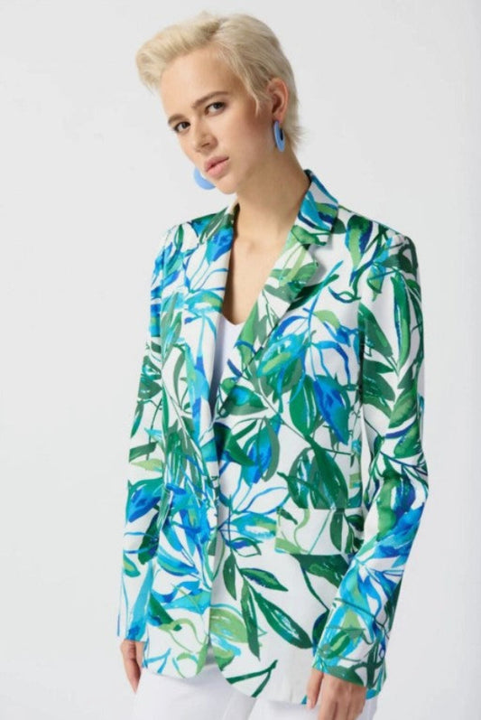 Woman wearing a tropical leaf patterned blazer on a white background