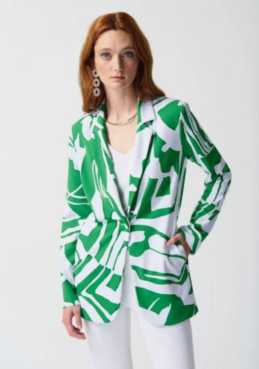 Woman wearing a green and white patterned blazer on a white background