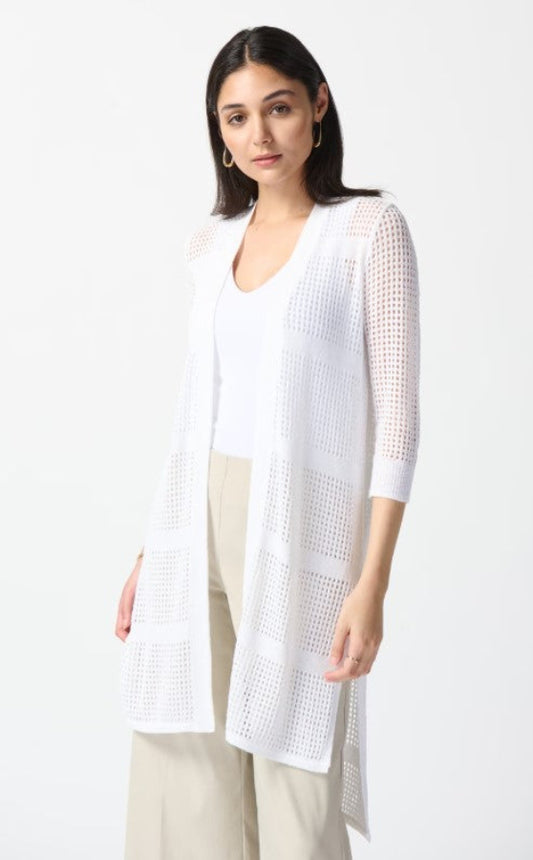 Woman wearing a white long cover-up over a white shirt on a white background