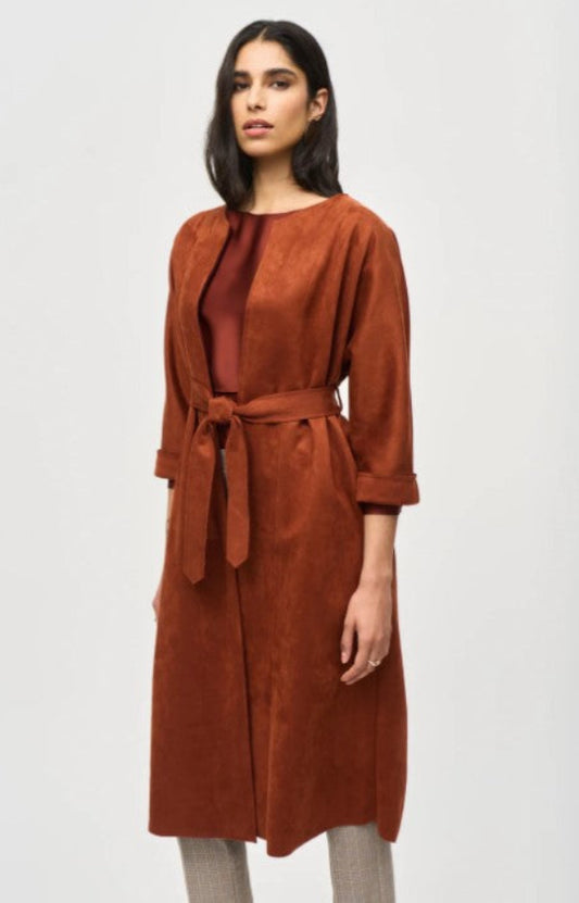 Woman wearing a brown suede coat on a white background