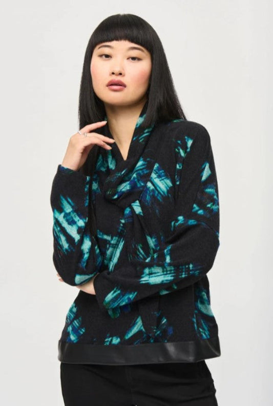Woman wearing a black and blue patterned sweater on a white background