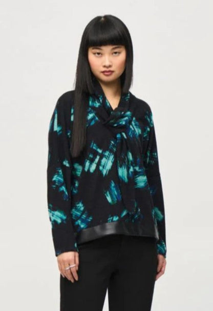 Woman wearing a black and blue patterned top against a white background