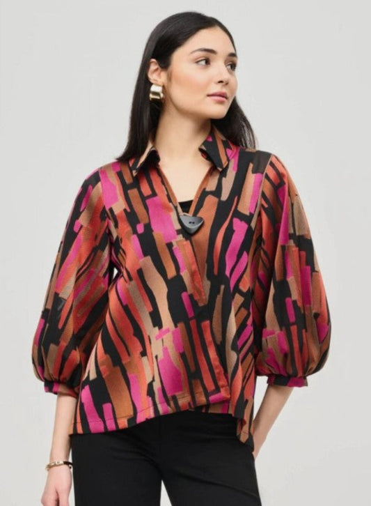 Woman wearing a colorful patterned jacket against a plain background