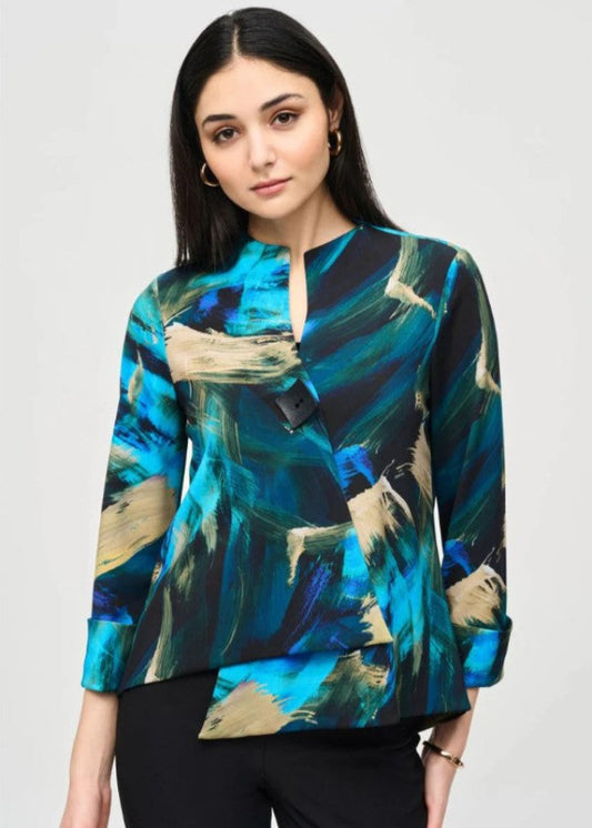 Woman wearing a colorful abstract patterned jacket on a plain background