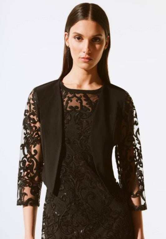 Woman wearing a black lace bolero on a white background
