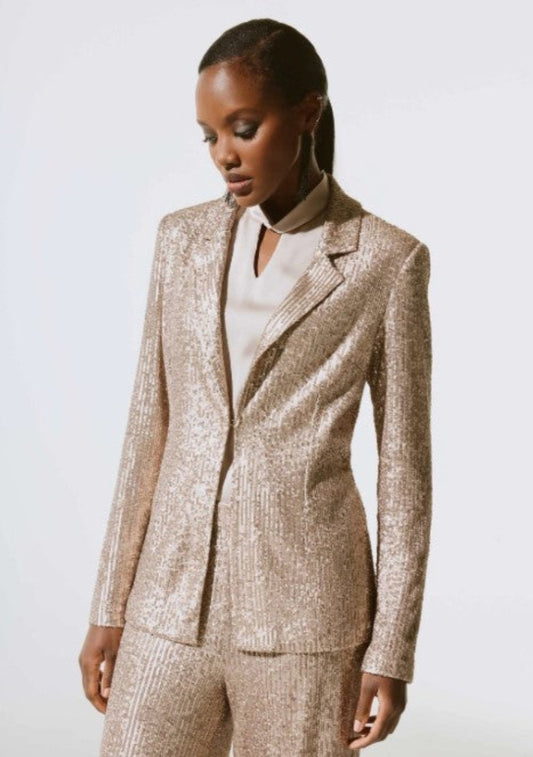 Woman wearing a beige suit against a white background