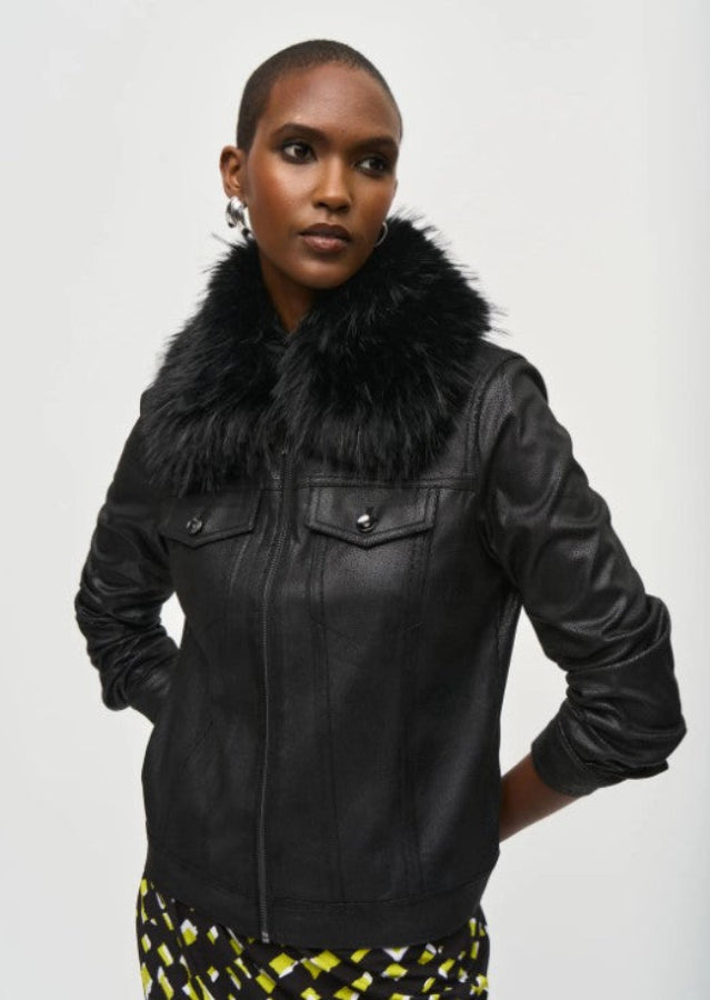 Woman wearing a black leather jacket with a fur collar on a white background