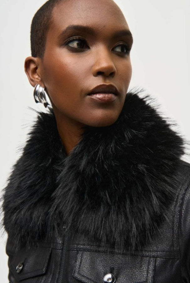 Woman wearing a black fur collar with a plain background