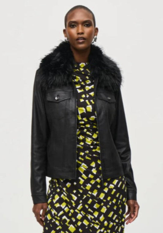 Woman wearing a black leather jacket with fur collar and a patterned dress on a white background