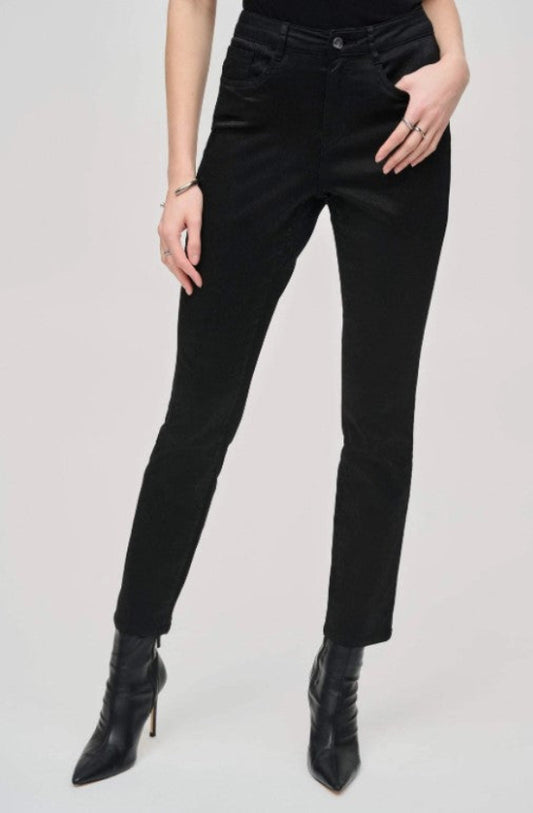Person wearing black pants and black boots on a light gray background