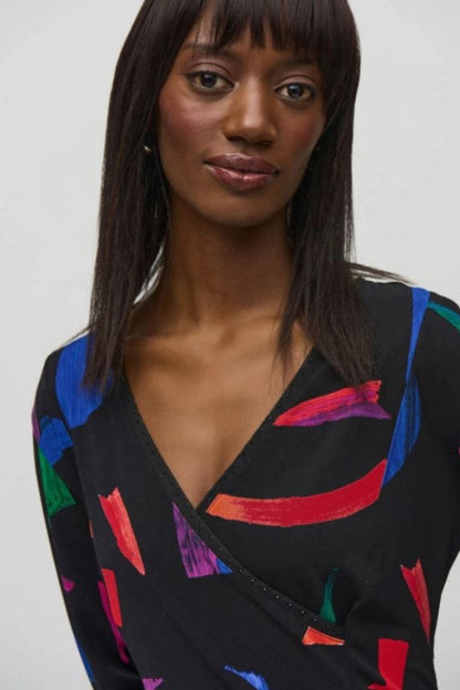 Woman wearing a black dress with colorful abstract patterns on a white background