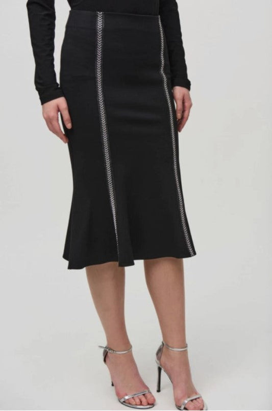 Black skirt with white trim worn by a person on a white background