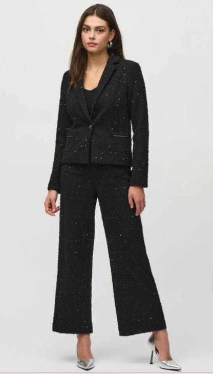Woman wearing a black suit with a white background
