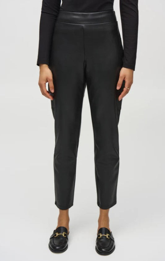 Person wearing black leather pants on a white background